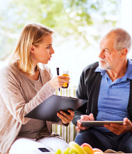 caregiver talking with senior man