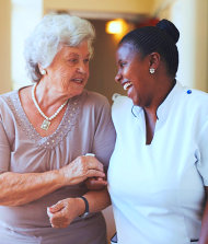 caregiver and senior woman smiling