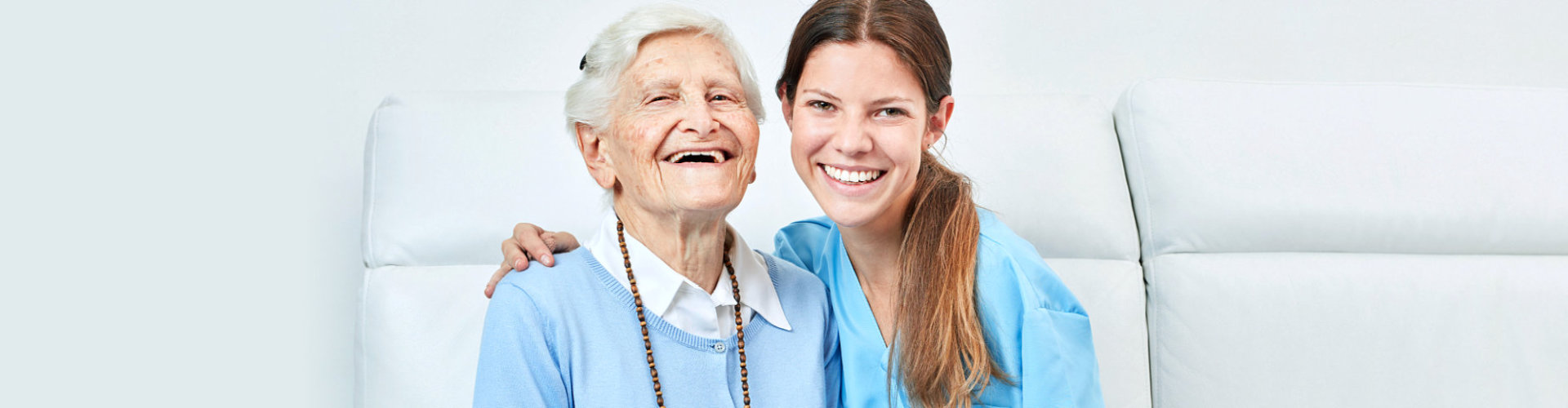 caregiver and senior woman smiling