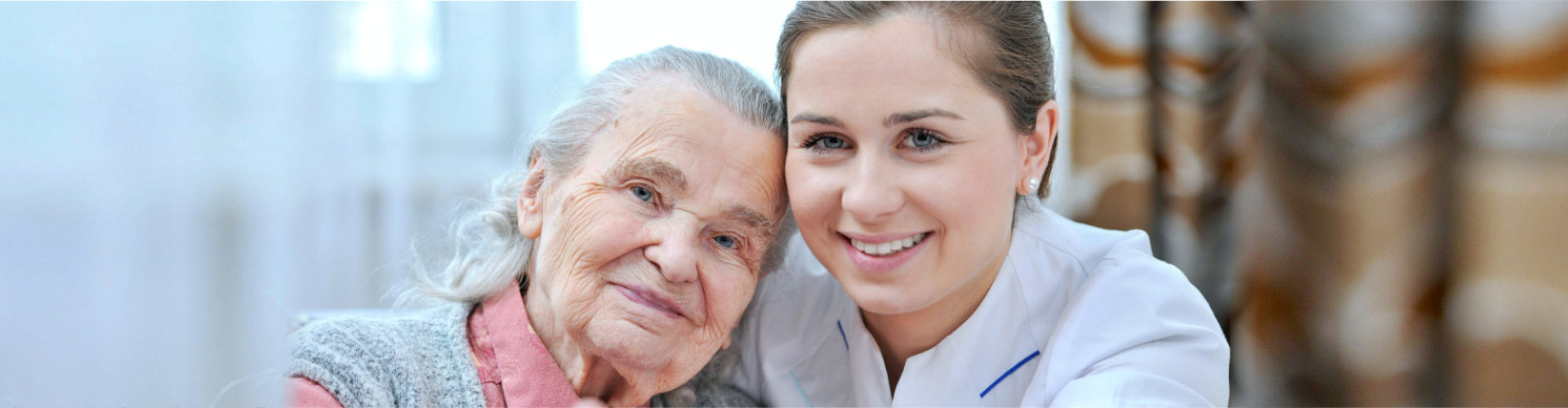 caregiver and senior woman smiling