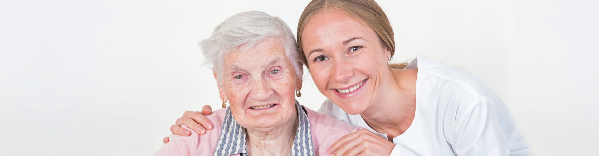 caregiver and senior woman smiling